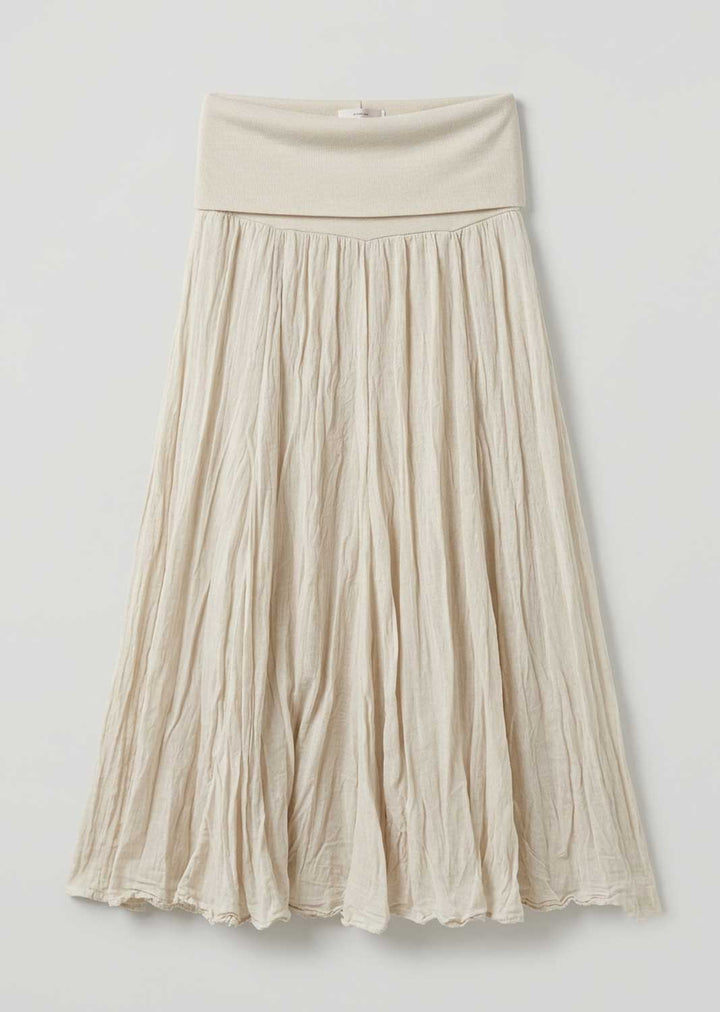 A cream-colored pleated midi skirt with a wide elastic waistband, shown against a plain light gray background.