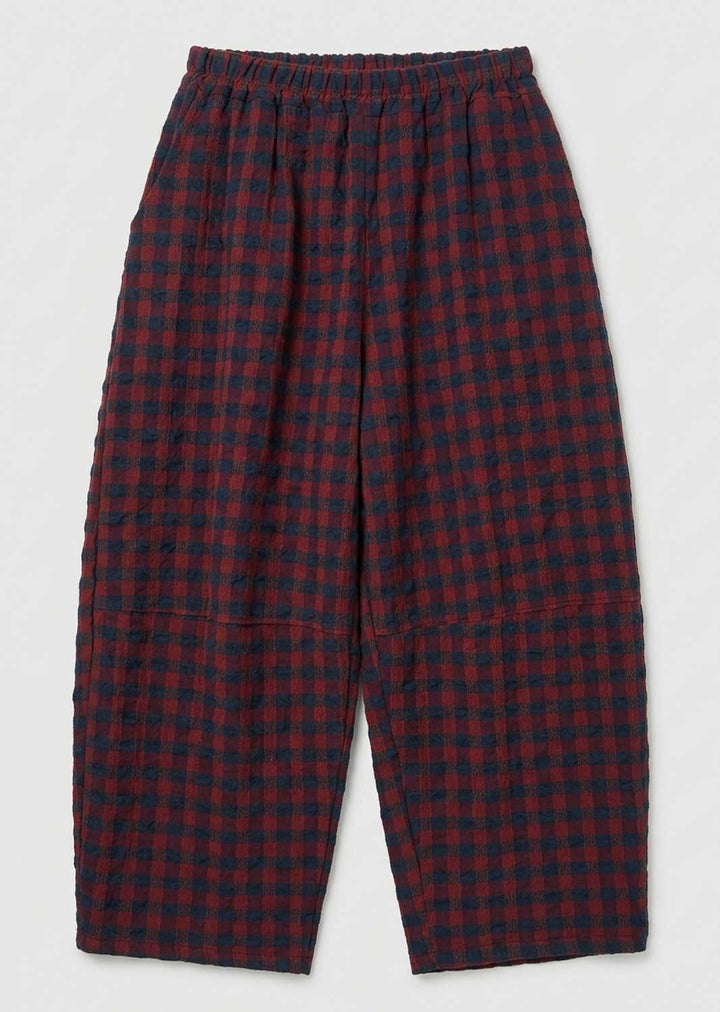 Red and navy blue checkered cropped pants with an elastic waistband, shown flat against a light gray background.