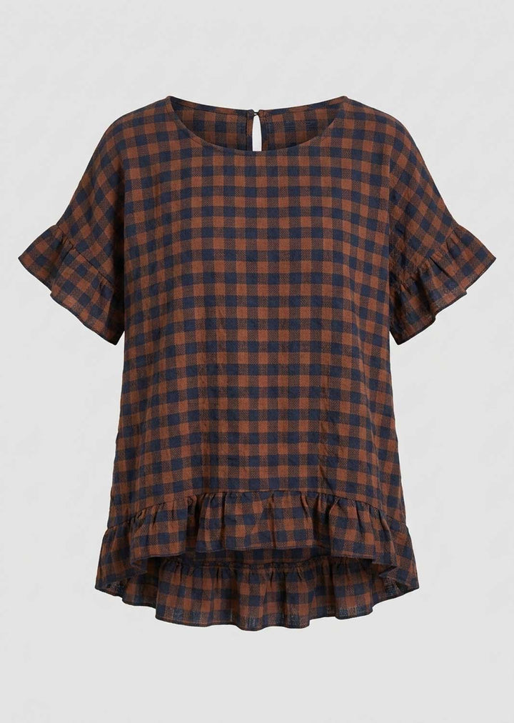 A short-sleeve plaid top with ruffled sleeves and a ruffled hem, shown against a light gray background. The pattern is a mix of dark brown and navy blue.