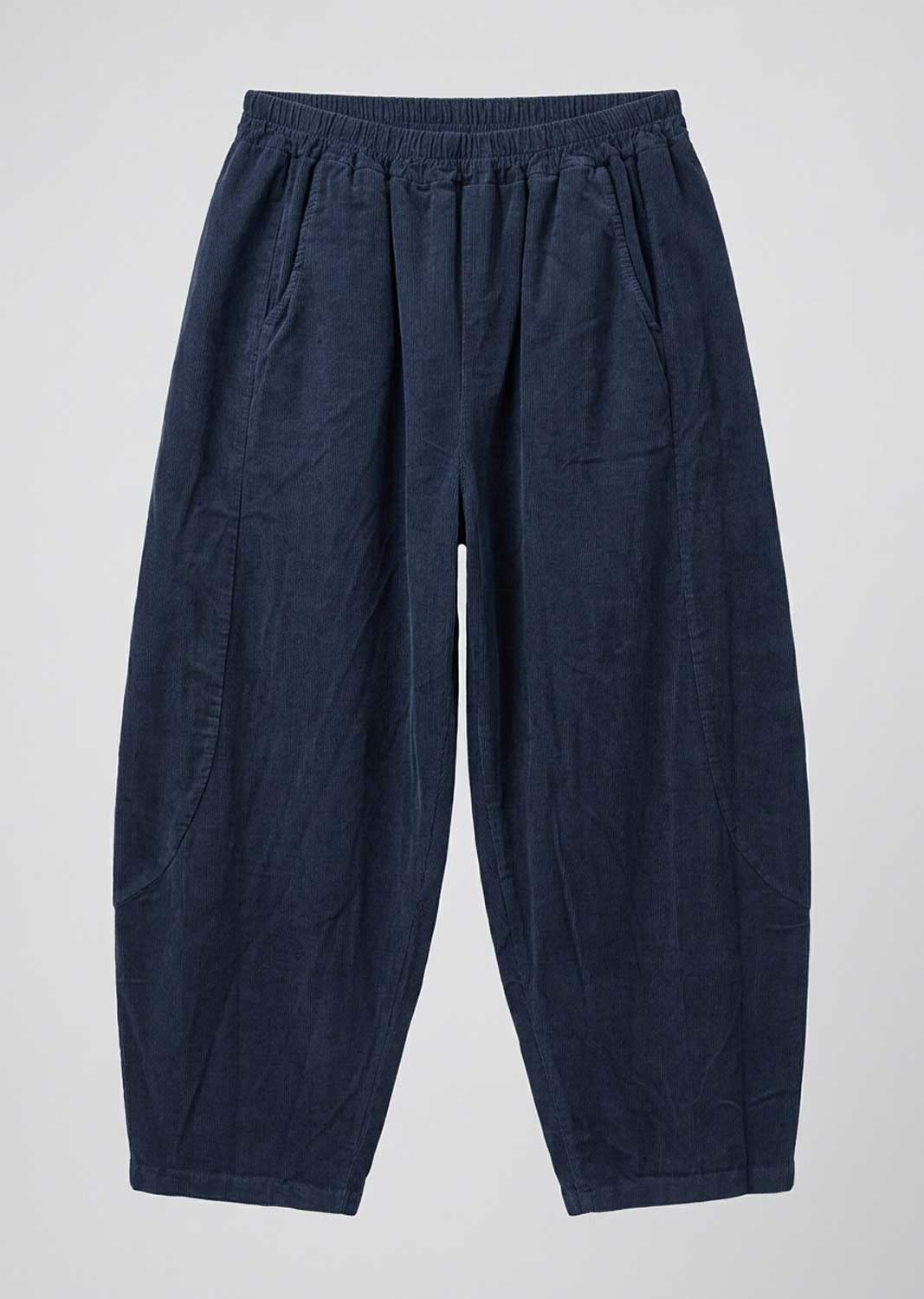 A pair of dark navy blue relaxed-fit barrel leg pants with an elastic waistband, laid flat against a light gray background.