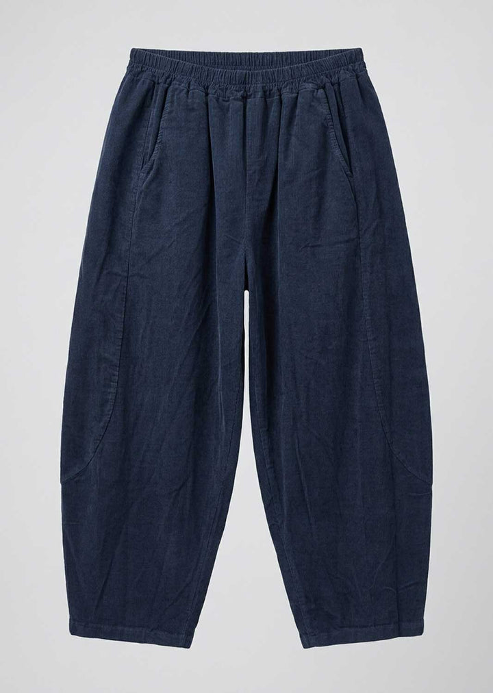 A pair of dark navy blue relaxed-fit barrel leg pants with an elastic waistband, laid flat against a light gray background.