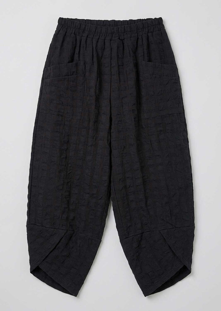 navy textured cotton cropped pants with an elastic waistband, side pockets, and a subtle crinkle pattern, shown flat on a light gray background.
