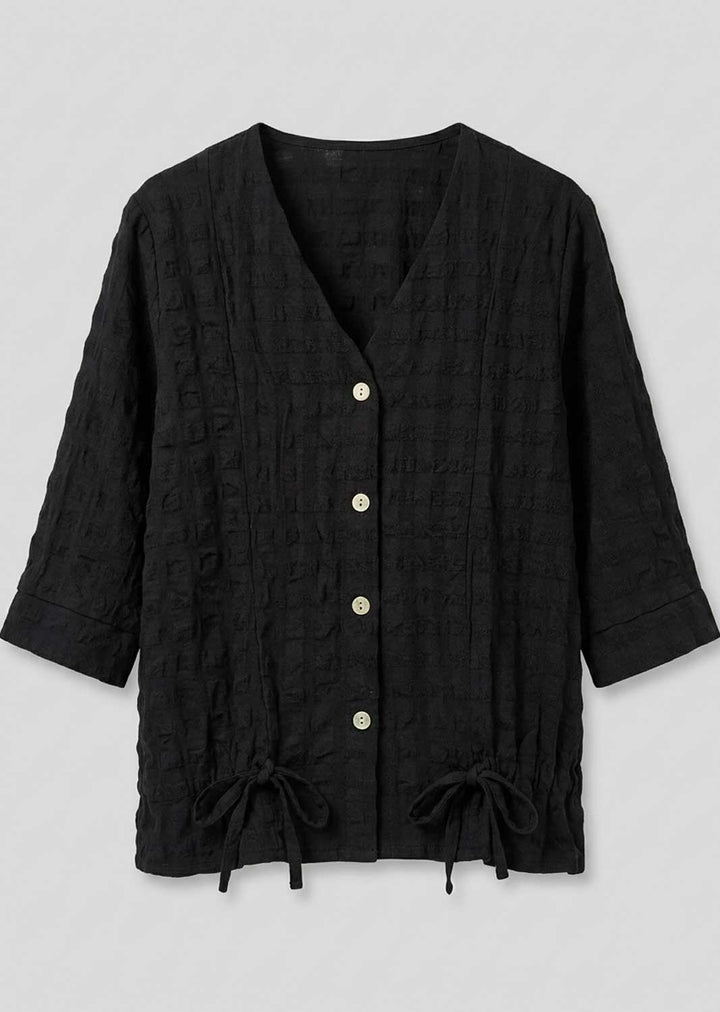 A black textured, short-sleeved button-up cardigan with drawstring ties at the hem, displayed flat against a light gray background.