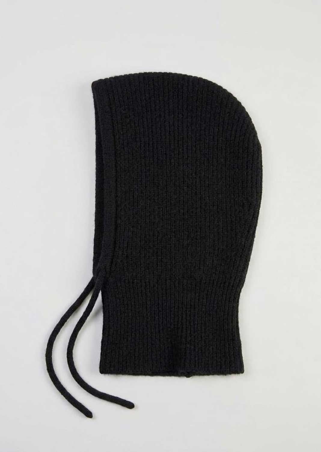 A black ribbed knit hood with drawstrings, laid flat on a light gray background.