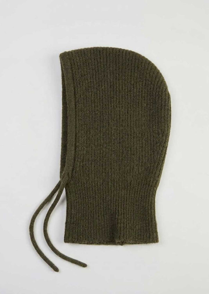 An olive green ribbed knit bonnet with drawstrings, laid flat on a light gray background.