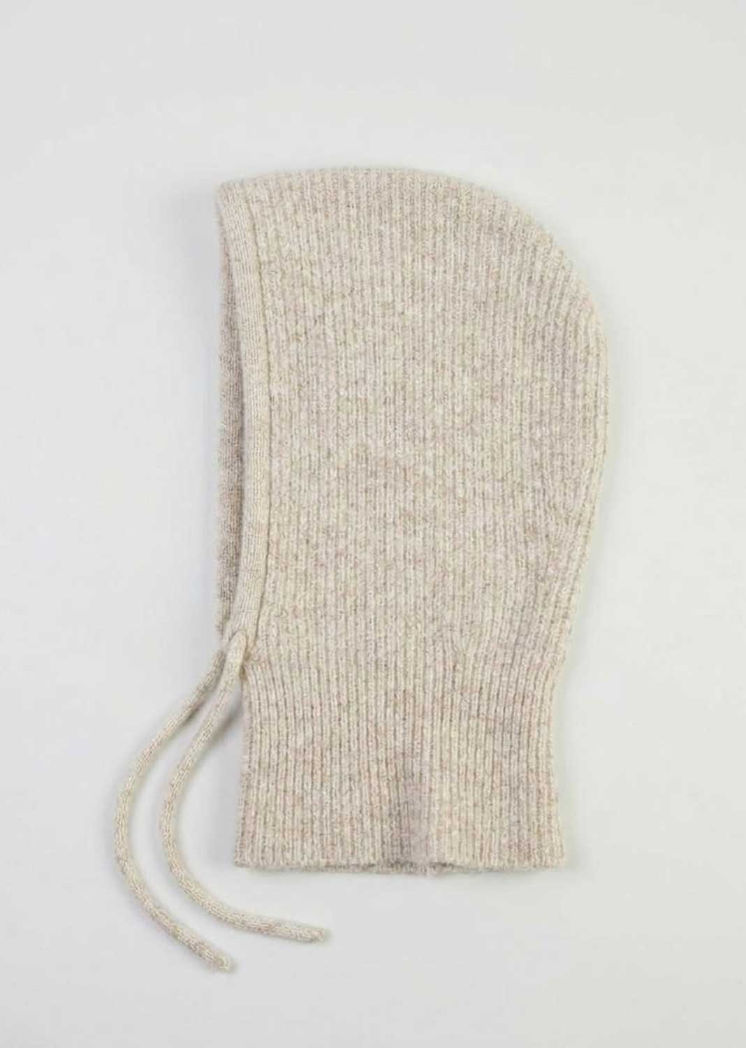 A light beige knit hood with a drawstring, shown flat against a plain white background.