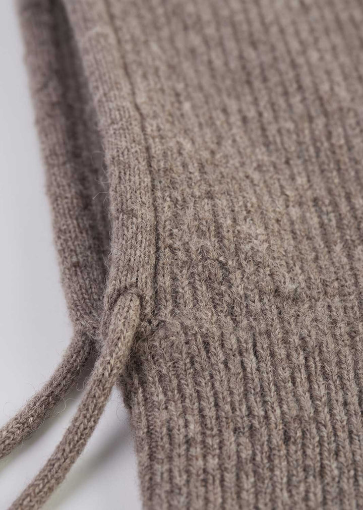 Close-up of a ribbed knit garment in a heather taupe-brown color, showing the texture and a drawstring detail against a plain white background.