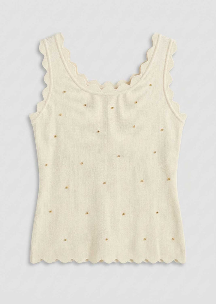 An off-white ribbed knit tank top with scalloped edges on the scoop neck and hem, decorated with small scattered gold embroidered dots, shown against a light gray background.