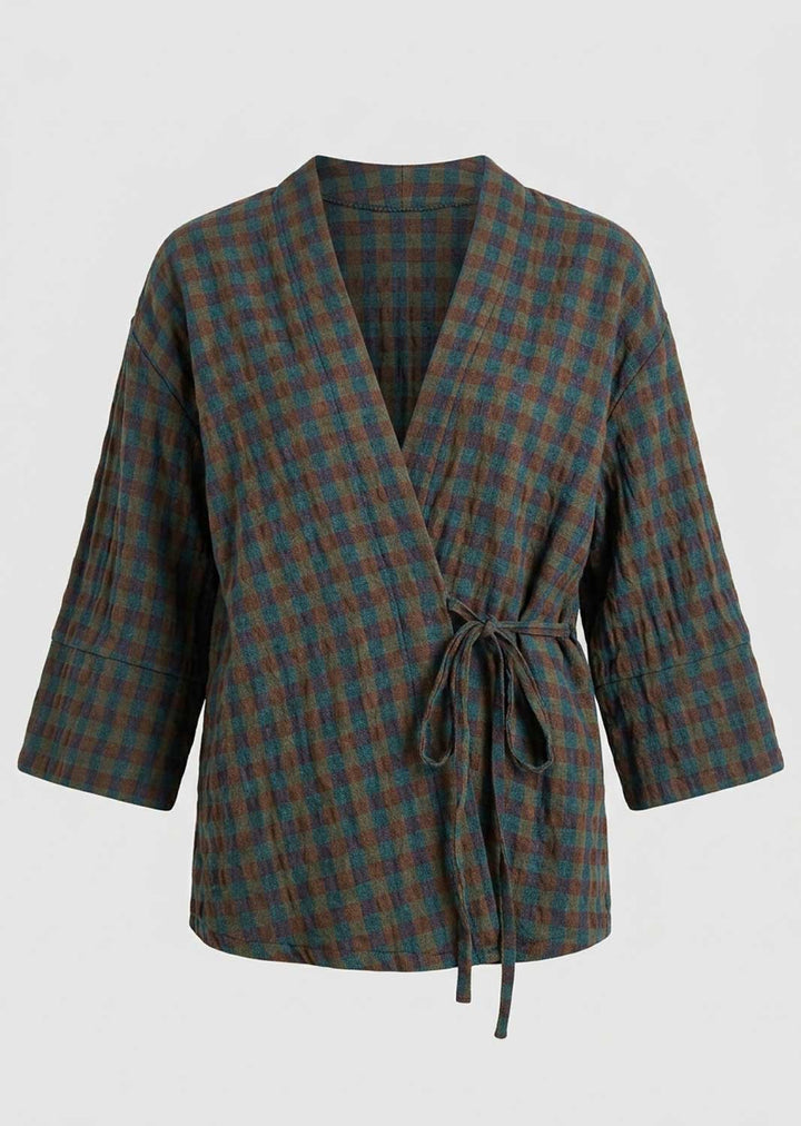 A plaid wrap jacket with three-quarter sleeves and a self-tie belt, featuring a textured fabric in dark green and brown tones, shown against a plain light gray background.