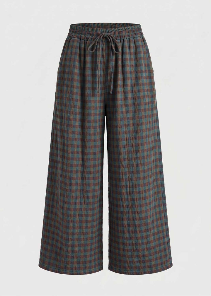 A pair of wide-leg cropped pants featuring a dark green and brown plaid pattern, an elastic waistband, and a matching drawstring, shown against a plain light gray background.