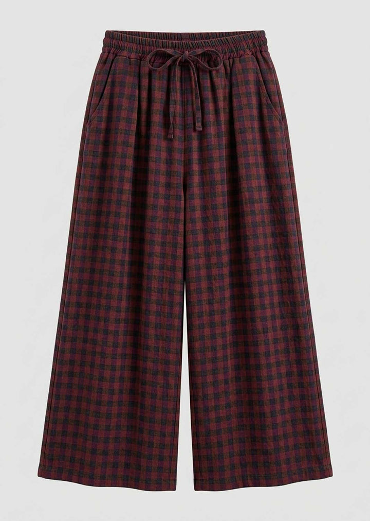 Plaid wide-leg cropped pants in a dark red and black checkered pattern, featuring an elastic drawstring waistband, shown against a light gray background.