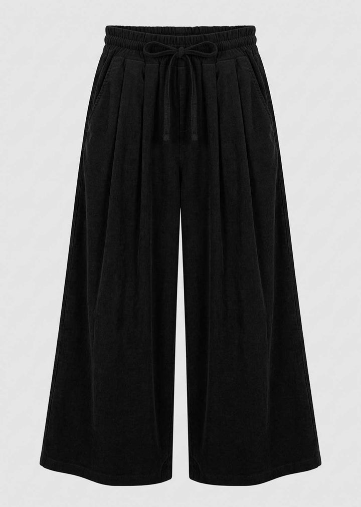 Black wide-leg pants with an elastic drawstring waistband, shown against a light gray background.