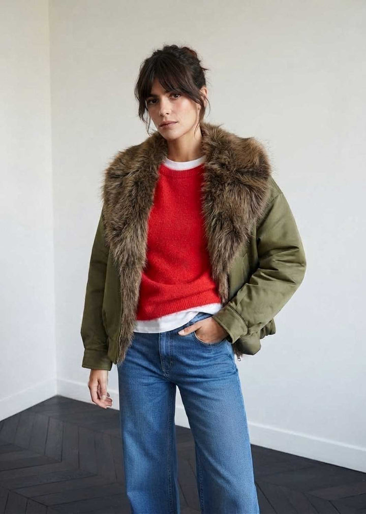 A woman wearing an olive green puffer jacket with a large brown faux-fur collar, 