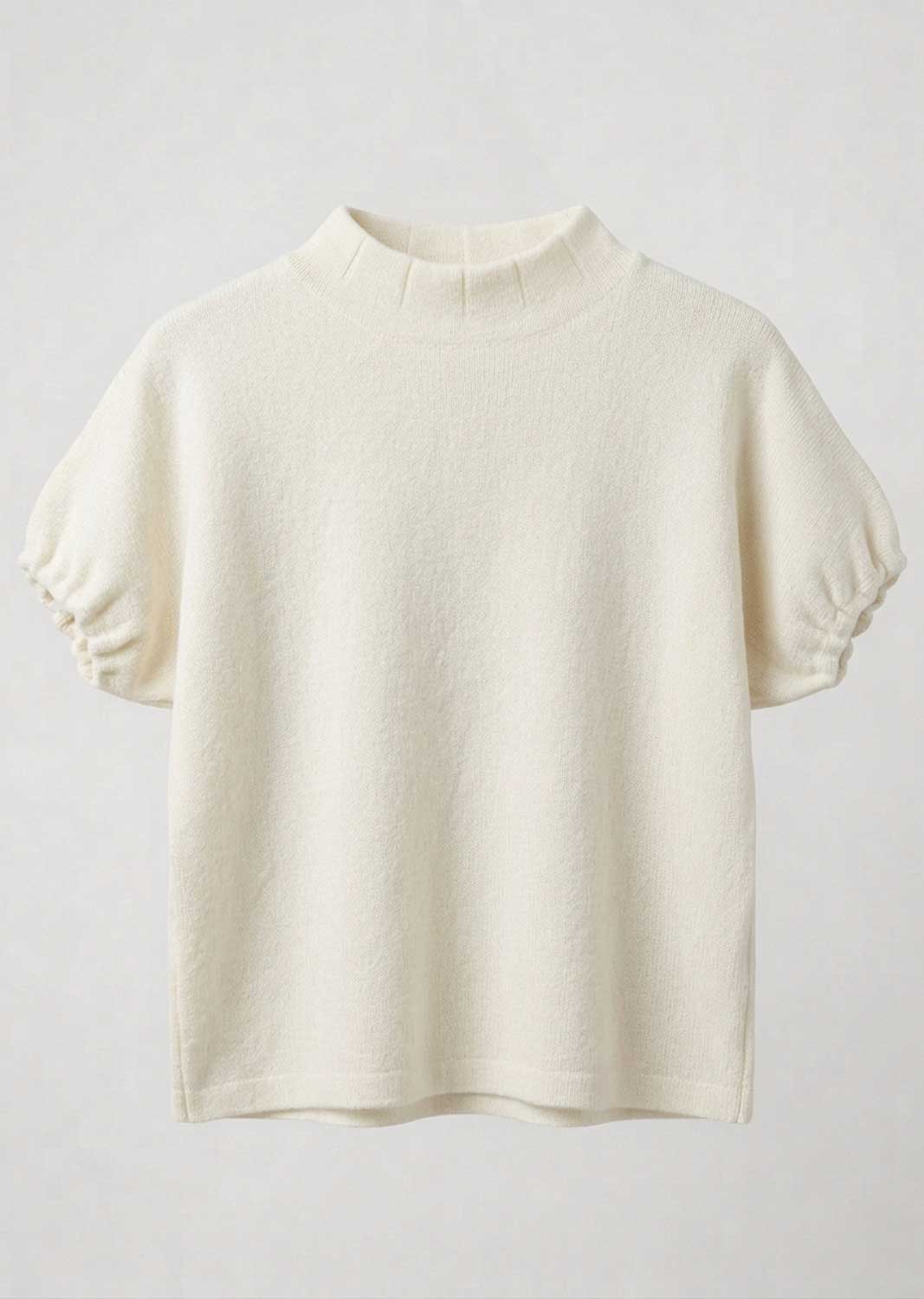 An off-white short-sleeve knit top with a mock neck and gathered puff sleeves, displayed against a light gray background.