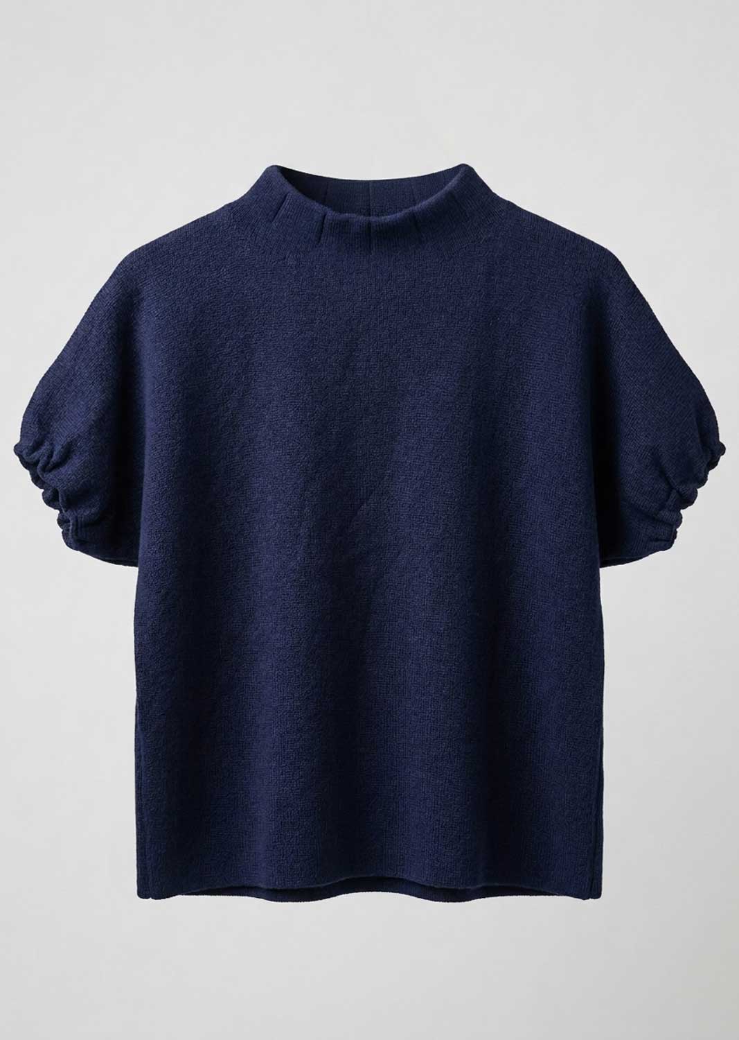 A navy blue knit top with a mock neck and voluminous elbow-length puff sleeves, shown against a light gray background.