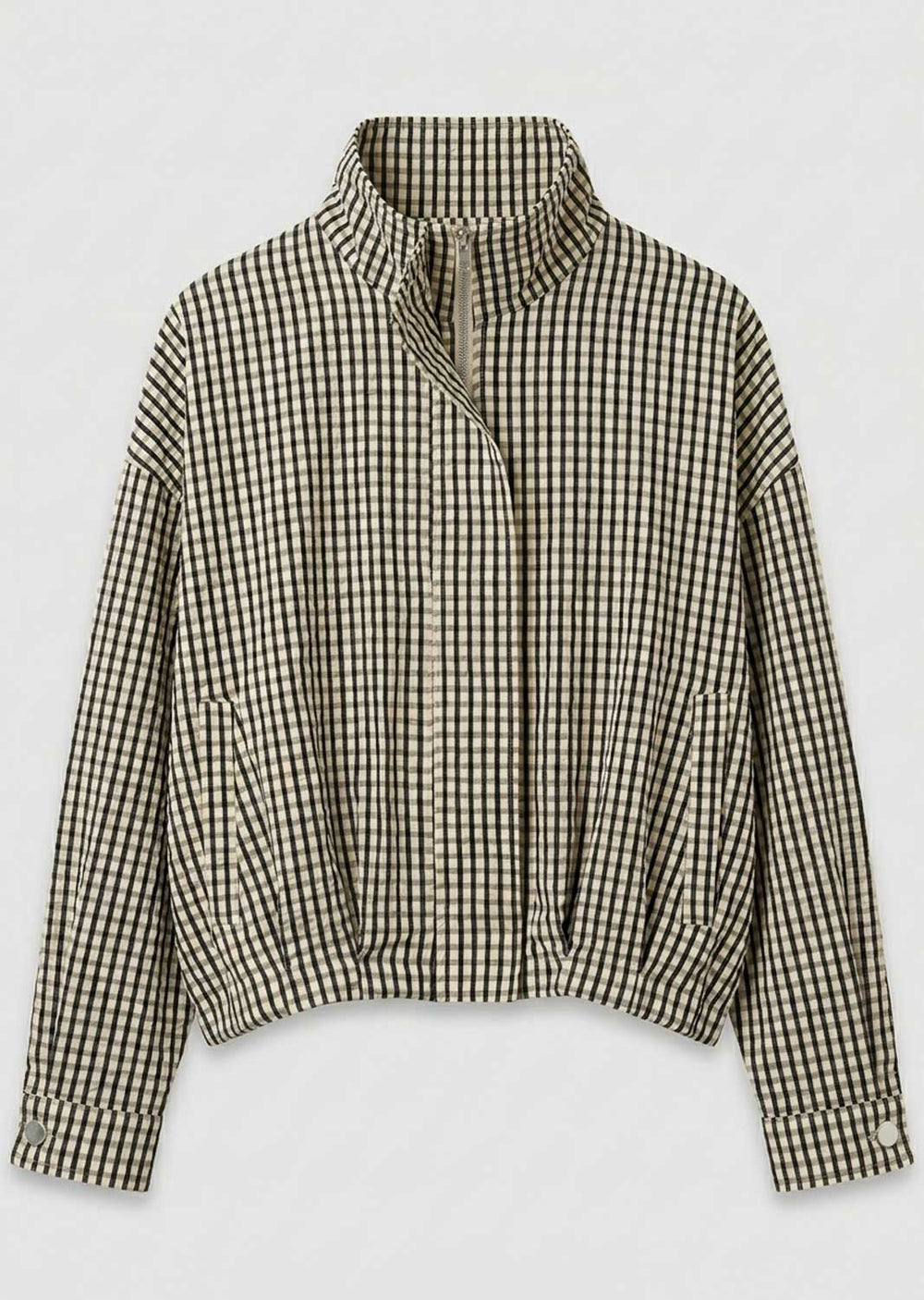 A cropped long-sleeve jacket with a high stand-up collar and an asymmetrical zipper closure, featuring a black and beige gingham check pattern, shown against a plain light gray background.