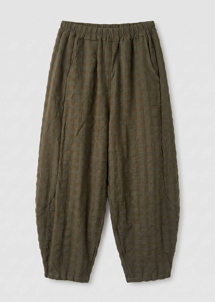 Olive green textured pleated trousers with an elastic waistband, laid flat on a light gray background.
