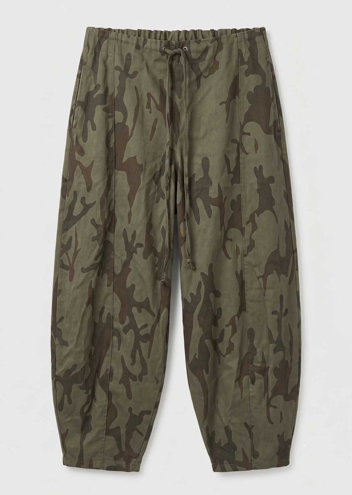 A pair of relaxed-fit camouflage pants in olive green and brown, featuring an elastic drawstring waist and tapered legs, shown flat against a light gray background.